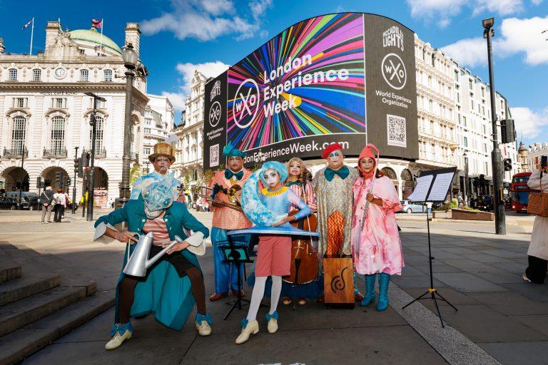 Demiurgo's El Grillo players from Mexico officially launch LXW26 at Piccadilly Lights.